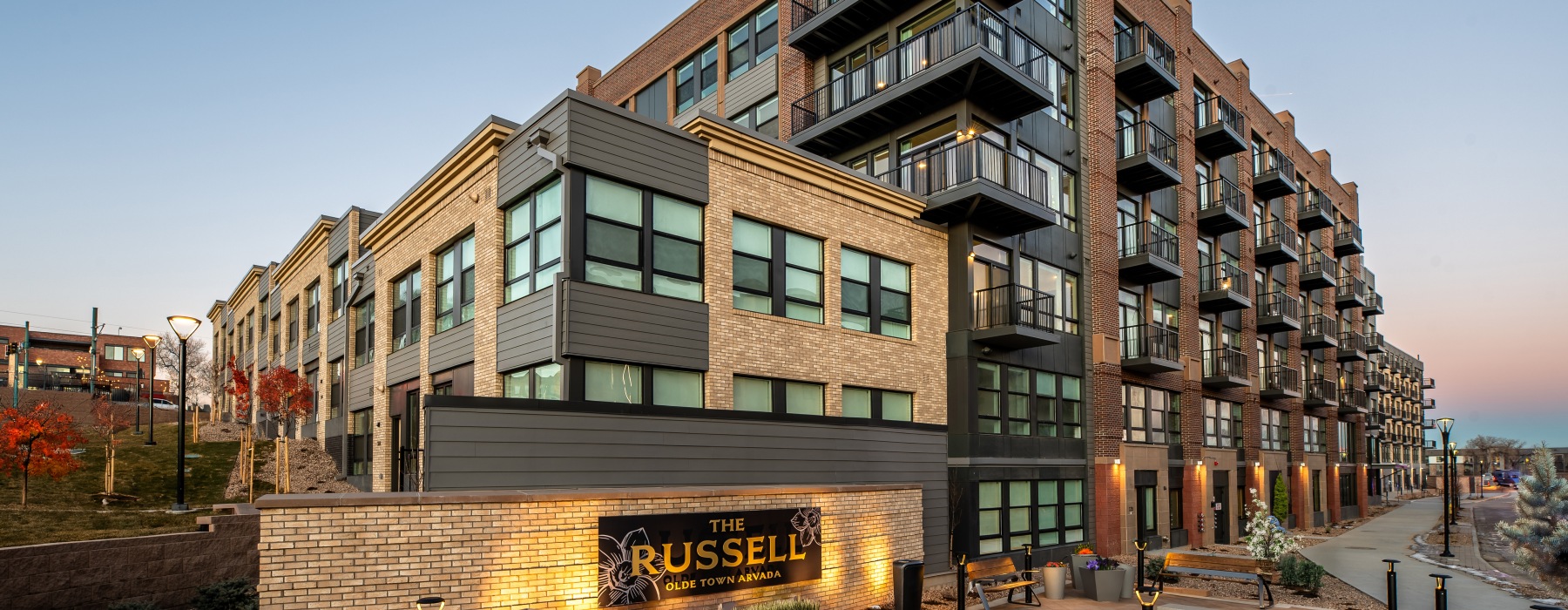 exterior of a building with many windows and sign in front