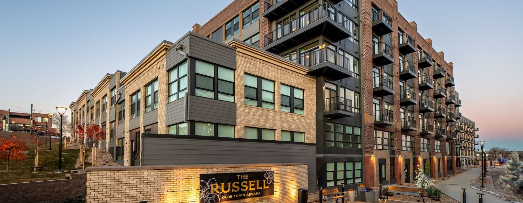 exterior of a building with many windows and sign in front